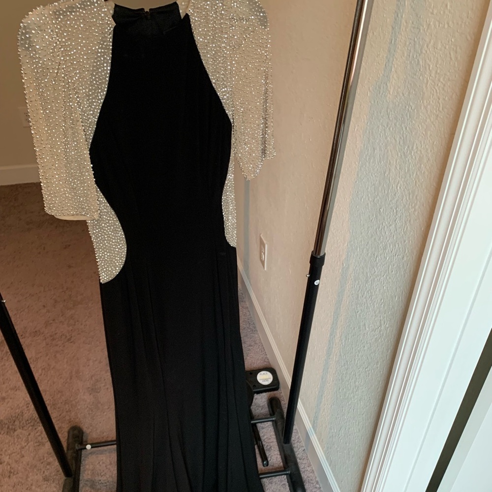 Xscape black formal gown, size 8. Sleeves and flank areas with beading.